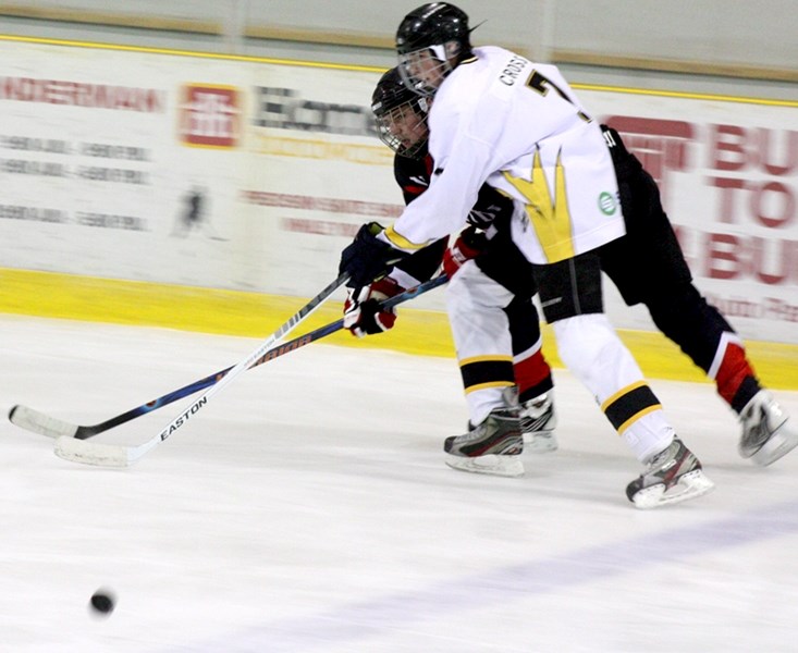 Johnathan Cross fights with a Vegreville player for the puck in a speedy race down the ice. Though the Renegades lost their game, they have proven Barrhead is not giving up
