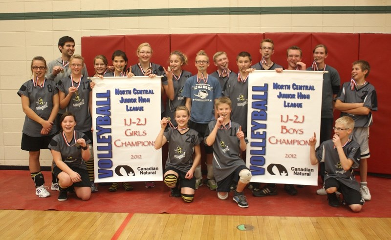 Junior boys and girls hold their victory banners with pride after winning the championship Nov. 17. Back (from left): Kira Dejong, coach Quinton Harthoorn, Martina VandeRiet, 