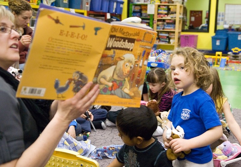 Serena Plitt, 4, listens very carefully to Parent Link coordinator Rhonda Waggoner reading Old McDonald had a Woodshop, waiting for her goat to make an appearance in the book.