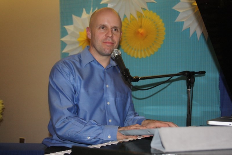 Piano man: Multi-talented Matt Day was the guest entertainer at Neerlandia &#8216;s dinner and auction.