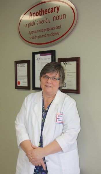 Taking a stand: Rita Lyster in her white lab coat inside her pharmacy.