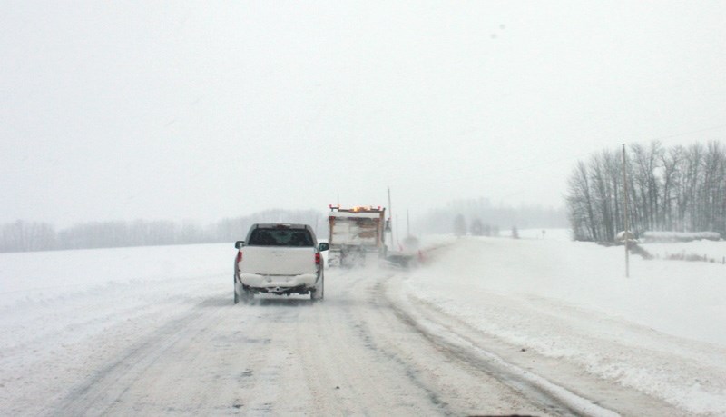 A Carillion snowplow seen operating on Secondary Highway 654, near Manola, shortly after 5 p.m. last Friday. Earlier, Carillion had pulled its plows from the highways because 