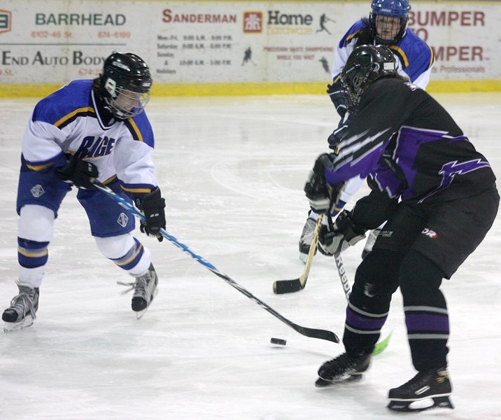 Rich Valley &#8216;s Amie Stilson has control of the puck in the &#8216;A &#8216; final against Fort Assiniboine. Alice Sloan is in the background.