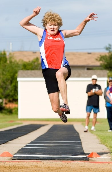 Edmonton athlete Lucille Burton leaps high into the air during the women &#8216;s 70+ long jump event in Barrhead at the Alberta 55 Plus Summer Games July 25-28.