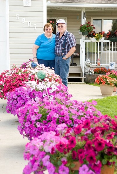 Barrhead residents Joyce and Arnold Christianson take pride in the bushels of beautiful flowers sprouting from every corner of their home. Working as a team, the two have