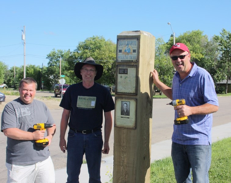 On the trail: Pictured putting up the first sign on the Blue Heron Walking Trail are, from left, Allan Cote, Fred Thistle and Shannon Carlson.