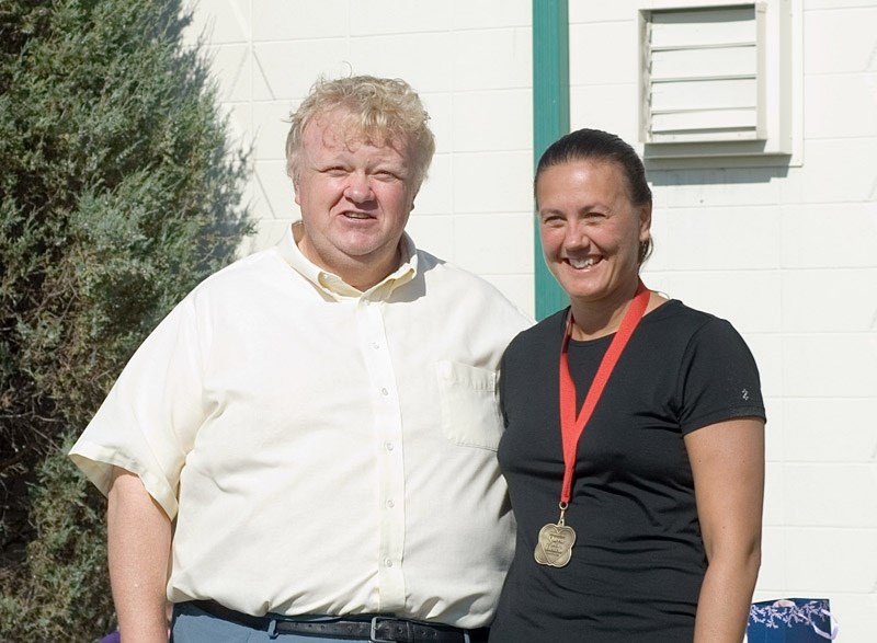After presenting medals to the winning participants, Barrhead mayor Brian Schulz stands with last year &#8216;s overall triathlon winner Barbara Petryshen-Kozak from Spruce