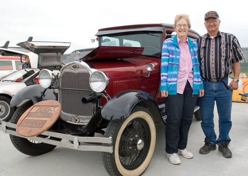John and Orriel Vobeyda from Barrhead stand beside the 1928 Ford Model A John restored. The couple has owned the car for about 15 years.