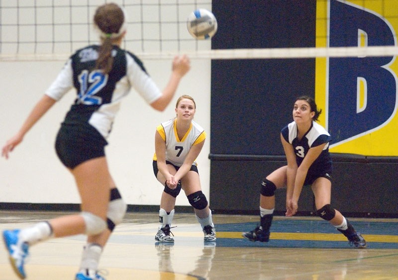 Senior Gryphon girls Avery Tarasiuk (left) and Derian Measures (right) ready themselves to return the ball to their opponents during the first tournament of the year.