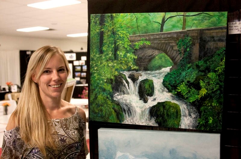 Mixed media artist Megan Pederson next to her striking painting, &#8220;A Walk In Ireland. &#8221; The work was recently exhibited in Edmonton after being displayed at a