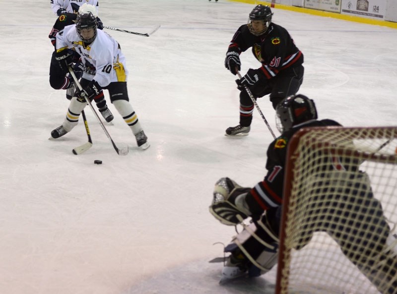 Brady DeRudder, who got two assists for the Pirates in their pre-season game Saturday night, battles to bring the puck towards the net.