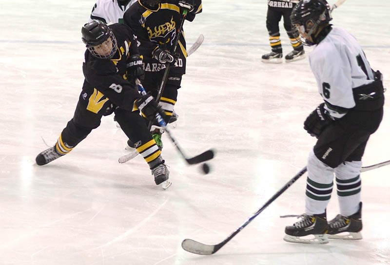 Barrhead PeeWee Flyers player Justin Haltiner, who scored the third goal of the final game, shoots the puck past a Spruce Grove Titans player Nov. 3.