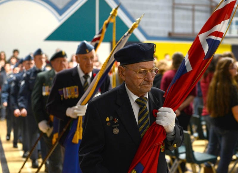 World War II veteran Bill Dewitz marches in with the colours to begin the Barrhead Composite High School Remembrance Day ceremony Nov. 7.