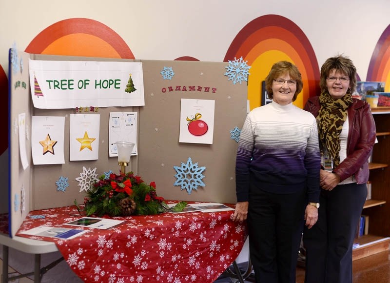 Administrative assistant Glenna Sheridan and Healthcare Center site manager Lois Burletoff stand beside the Tree of Hope display in the Barrhead Healthcare Center. The