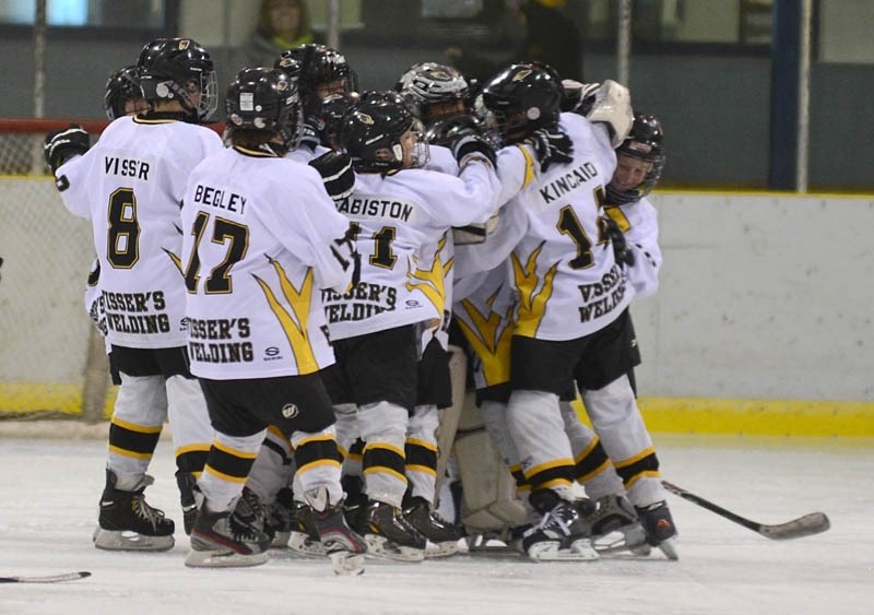 The Atom Hawks collect in a group and cheer after winning the weekend tournament A final championship game against Spruce Grove Nov. 17.