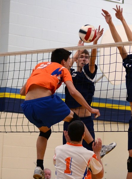 Mark Fountain jumps to meet and block his Morinville opponent. The Gryphons were able to claim a victory 25-13 and 25-16.