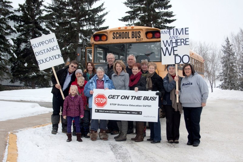 Signs of concern: Fourteen people get ready to board the Edmonton-bound bus outside the Alberta Distance Learning Centre in Barrhead on Saturday.