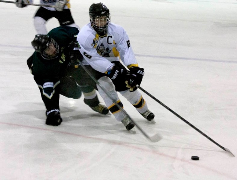 Brett Bujold shields the puck from a Ponoka player.