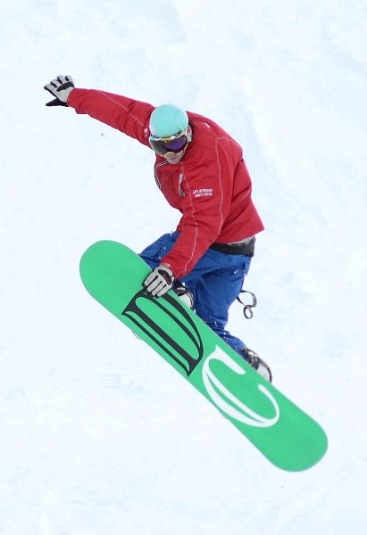 Twenty-year-old David Schembri gets some air with his snowboard during the opening weekend at Misty Ridge Ski Hill.