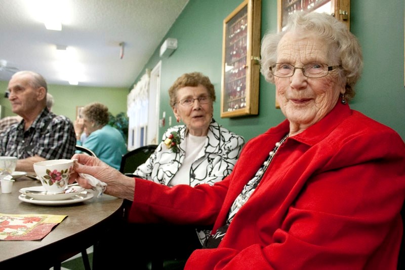 Lady in red: Marge Gallatin (right) and Gerry Kruse enjoy cups of tea during Hillcrest Lodge &#8216;s Christmas tea party.
