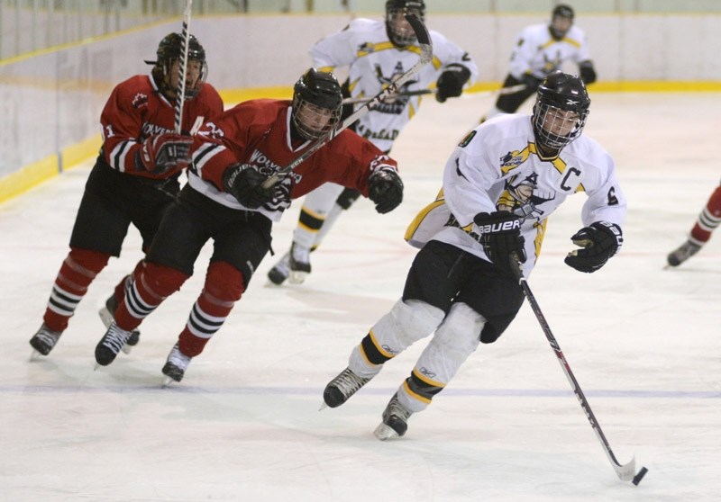 Pursued by two opposing players, Steelers captain Brett Bujold powers down the ice with the puck during the Steelers game against Whitecourt Friday night.