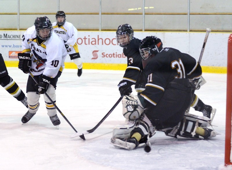 After powering down the ice, Pirates player Bradey DeRudder shoots the puck and lands a goal for Barrhead during the Bantam Pirates &#8216; first provincial game against