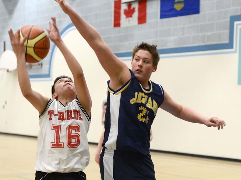 Jags player Tanner Whiting makes a block against R. F. Staples player during the junior high divisional tournament at Barrhead Composite High School over the weekend. The