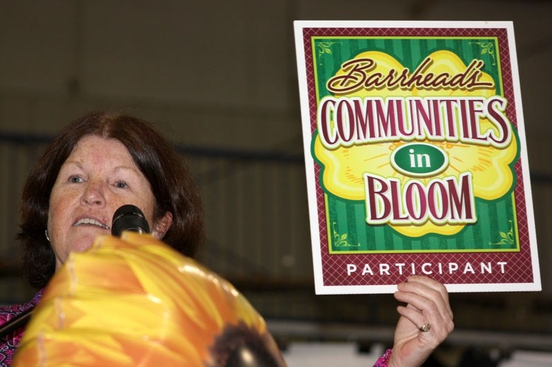 Speaking at the Volunteer Appreciation and Awards Night, Parks &#038;Recreation Director Sue Keenan displays the Communities in Bloom placard.