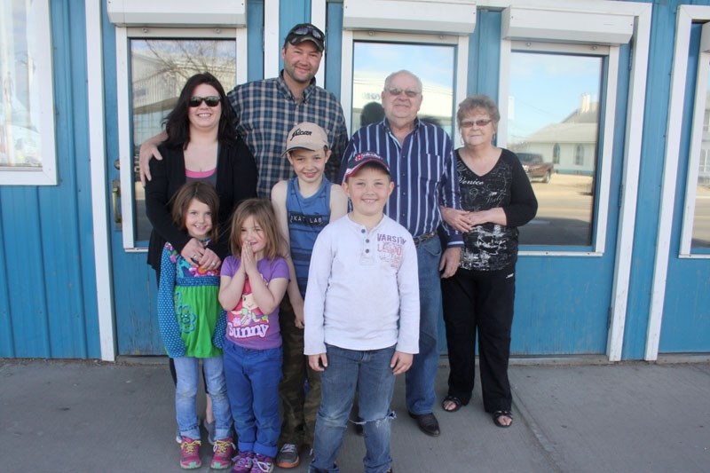 Changing hands: New Roxy owners Patrick and Sheana McKeen (back, left) with former owners Jim and Mary Carnegie. In the foreground are the McKeen children (left to right)