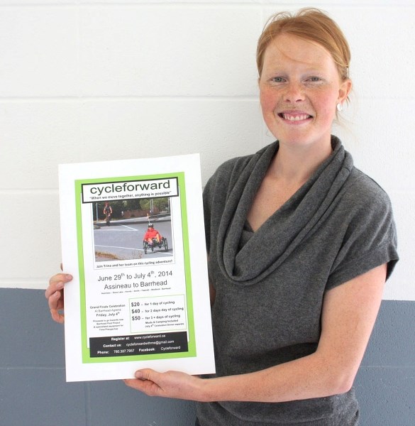 Courtney von Rennenkampff with a poster on the &#8220;cycleforward &#8221; ride.