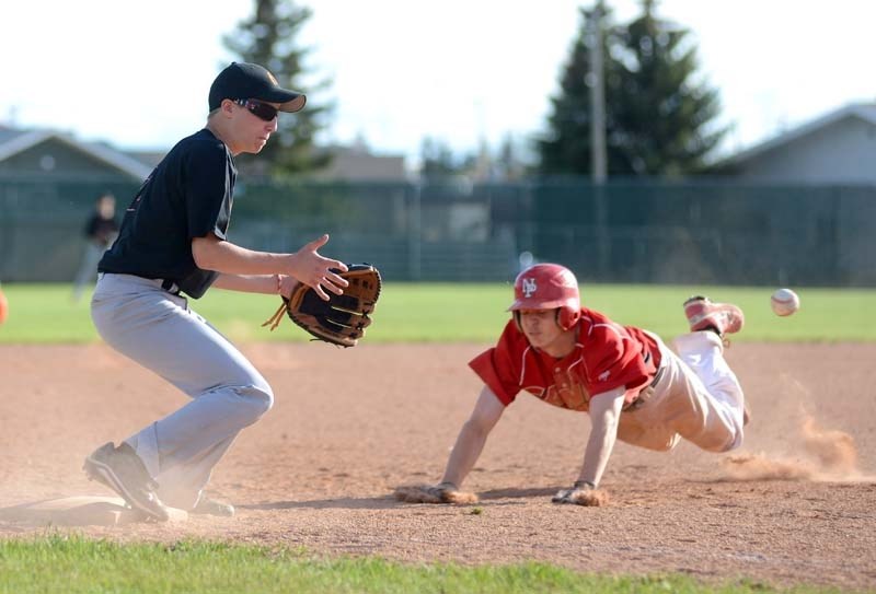 Barrhead Orioles player Nicholas Murrell prepares to make a catch as an opposing player from Slave Lake attempts to dive onto third base during a game Saturday, May 24.