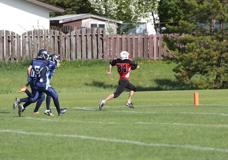 T-Birds player Jacob Kiselyk from Barrhead runs in a touchdown against Vegreville.