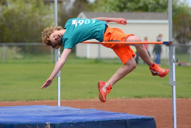 Landon Sonnenberg throws himself over the bar during the high jump event.