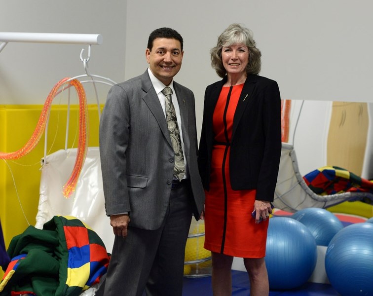Associate Minister of Services for Persons with Disabilities Naresh Bhardwaj stands with Barrhead &#8216;s MLA Maureen Kubinec in the Dr. Doug Fleming Sunshine Room June 6.