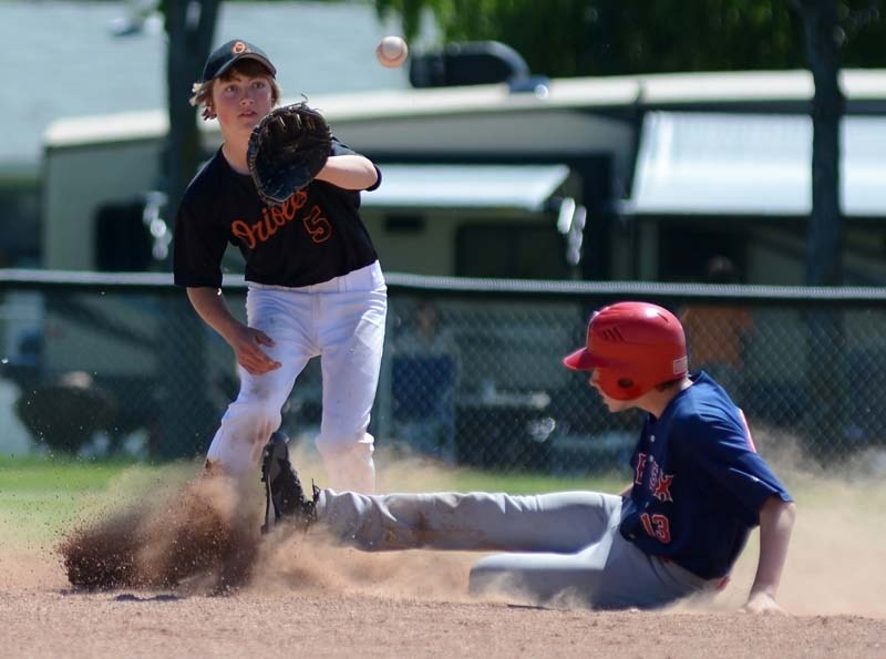Kyle Sommers gears up to make a catch at second base as a Fort Saskatchewan player slides in.