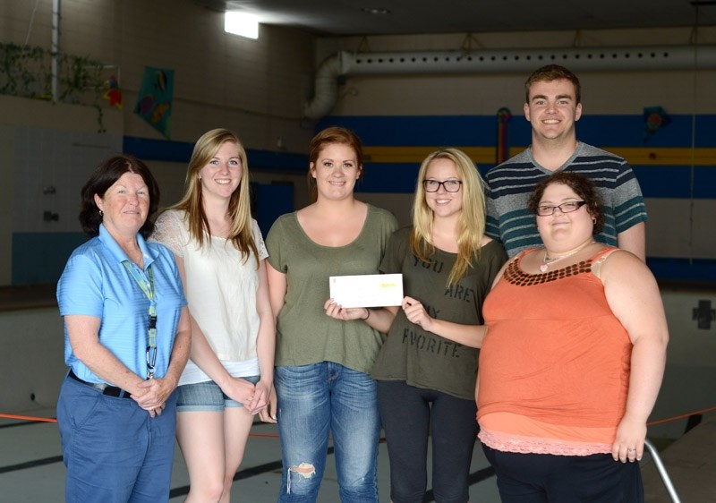 Barrhead Town Parks and Recreation staff received a cheque last week for over $8,000 from Barrhead Raptors Community Football to go towards the new swimming pool.