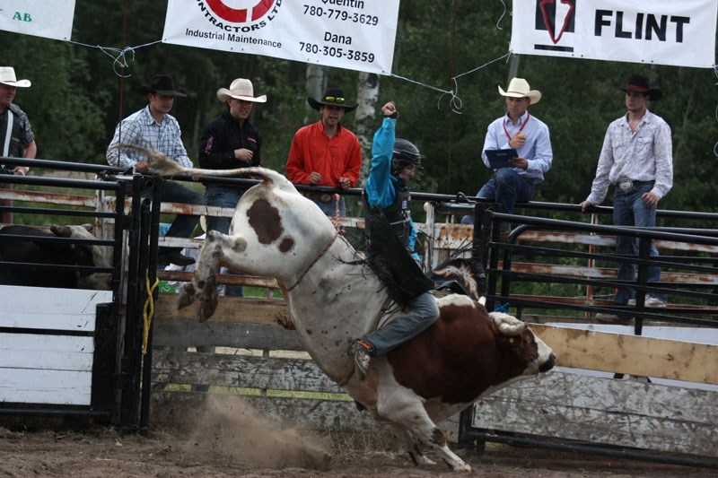Tim Lipsett rides a bull during the Sangudo Bull Bash on Saturday night at the Sangudo Agricultural Society. Of the 23 riders who competed, Lipsett had the longest ride and