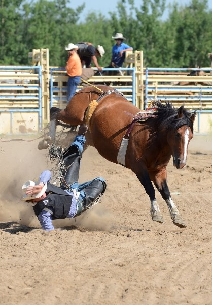 Aaron Letoureau hits the ground after getting bucked off his horse during the Bareback event at the 13th annual Highridge Rodeo July 12.