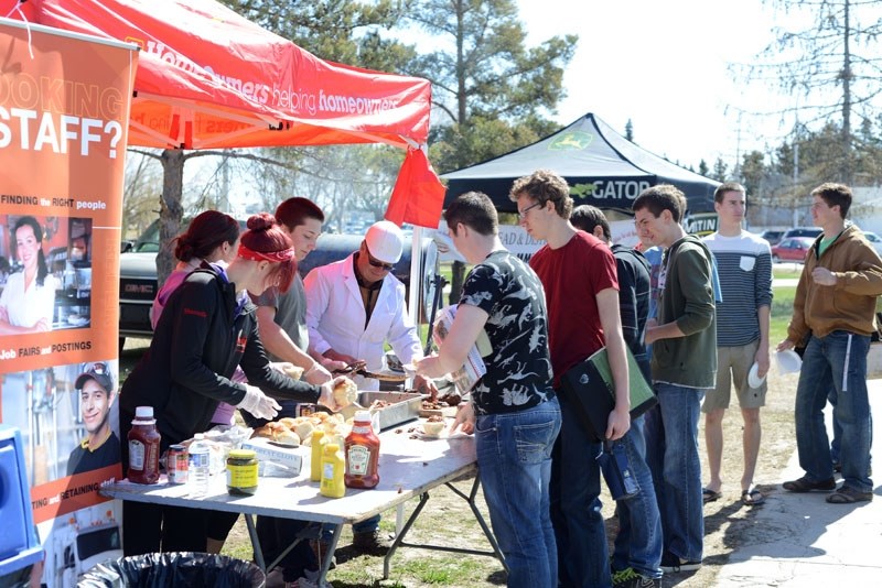 Barrhead&#8217;s first BBQ Cookoff organizer Dennis Ranger, owner of Barrhead Custom Meats, serves up hamburgers at a recent tailgate party at the Barrhead Composite High