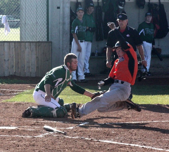 Orioles 2B Declan Kummer slides safely into home against the Whitecourt Rays.