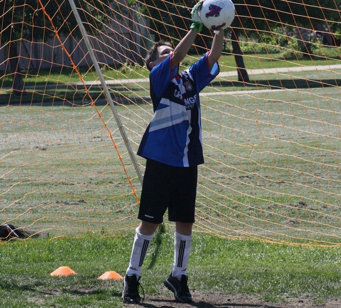 Connor Allen stretches to catch the ball during the Challenger Sports British Soccer Camp on Tuesday.