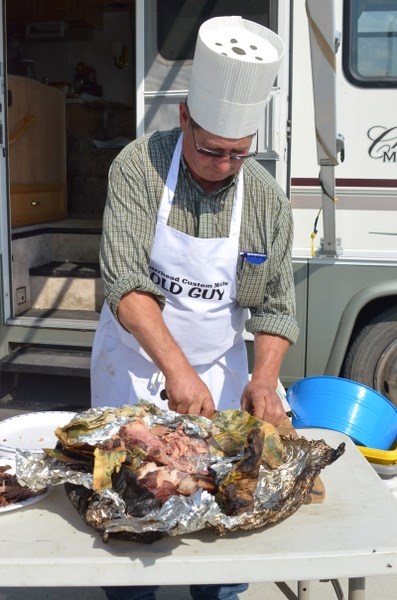 Dennis Ranger portions out some of his pork shoulder for residents to taste.