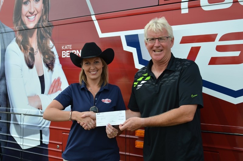 Kelly Fleming, Kraft Celebration Tour Brand Manager, presents Barrhead Curling Club President Brian MacGillvray with the real cheque for $25,000.