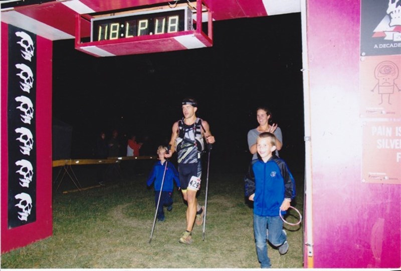 Tuininga crosses the finish line shortly after midnight after competing in the Death Race in Grande Cache, Alberta.