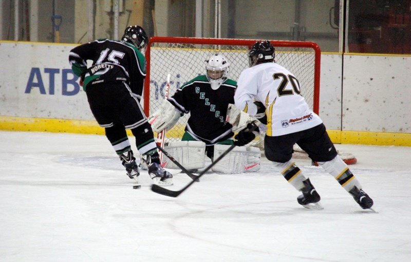 Pirates &#8216; player Mitch Carstairs attempts to sneak past Norette OIlers &#8216; player Colton Martindale, and heads straight for the goalie, Ryan Buchan.