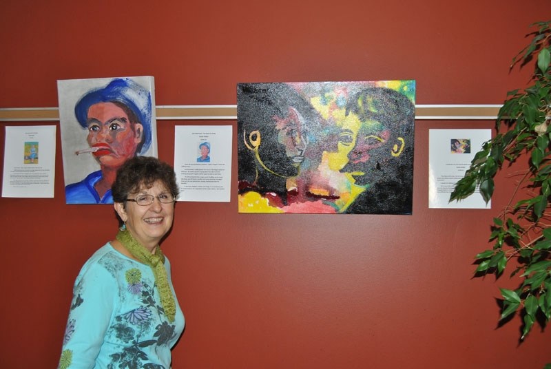 Barrhead artist, Maria Sieben, poses with her favourite painting in her narrative series, Light In August series.
