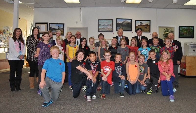 Jamie Fisher &#8216;s Grade 5 class poses with a group of Canadian Armed Forces Veterans Herman and John Barkemeyer, Bill Dewitz, Wilf Seal and Lyle Saumer.