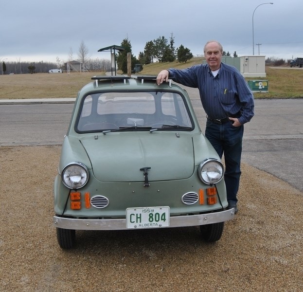 Stoik poses beside his most recent project, a 1959 NSU Prinz.