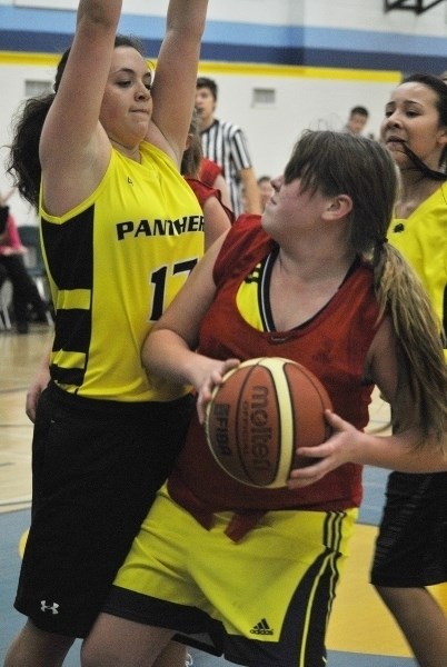 Morgan Lemp (with the ball) looks for an opening to shoot while being heavily defended.