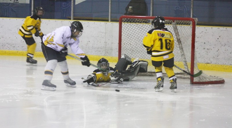 Kyle Kleinfeldt narrowly misses scoring during a scramble in front of the Stony Plain net.